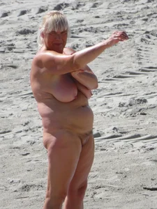 Mature blonde lady on a nude beach with big boobs