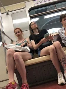 Two Girls With Hot Long Legs in Mini Shorts and Sneakers in the Subway Train Candid Photo Gallery