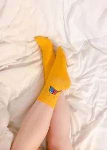Legs in Cute Socks in Bed Selfie