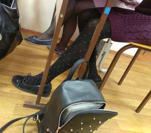 Skinny Legs in Black Pantyhose With Dots Under Desk in College Classroom
