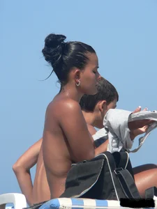 Hot ass topless beach girl with great tits lets her little brother oil up her ass in thong bikini