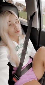 Sexy Blonde Girl in Pink Shorts Taking a Selfie in Her Car