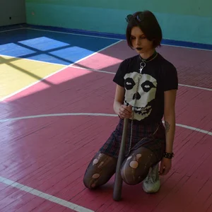 Skinny Teen in Torn Black Pantyhose Standing on One Knee Photo
