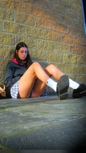 Girl Sitting on the Floor in a Skirt Revealing Panties While Standing Up
