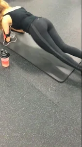 Sexy gym girl with a nice body in leggings as she works out