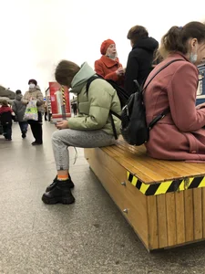 Cute girl sitting on a bench at the subway station creepthot, nice skinny legs in tight jeans, her ankles can be seen
