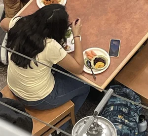 Chubby girl in tight jeans eating dinner