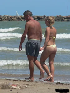 Sexy blonde on the beach in a yellow thong bikini