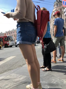 Closeup of nice legs and booty in denim shorts on a crosswalk