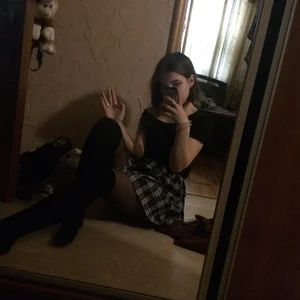 Girl in a Skirt and Black Pantyhose Sitting on the Floor Mirror Selfie