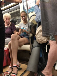 Tall Candid Teen Girl in Denim Shorts And Sandals Sitting in the Subway Train, Then Walking Down the Station