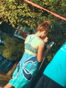 Sexy beach girl in a Nike sports bra and black bikini bottom