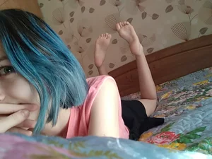 Girl with Blue Hair Lying in Bed with Cute Bare Feet Selfie
