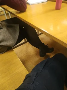 College Student's Crossed Legs in Black Pantyhose - Under Desk Photo in Classroom