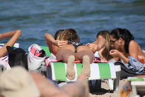 A couple sexy girls laying out on the beach