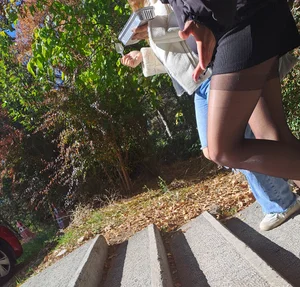 Teen wearing black pantyhose and a skirt, street sneaky photo