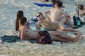 Girl in Sunglasses with Hot Stomach Lying on the Sand Beach Creepshots