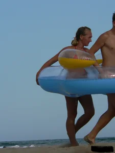 Sexy mom and daughter in red thongs at the beach