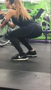 Sexy gym girl with a nice body in leggings as she works out