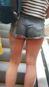 OC! Super cute brunette in jean short shorts with cheeks out and bikini tan lines up escalator! OC!