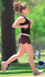 Cute girl running in short shorts
