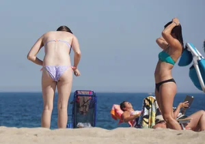 2 cute friends in bikinis on the beach