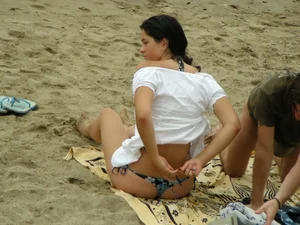 Sexy girl in a blue floral thong bikini at the beach