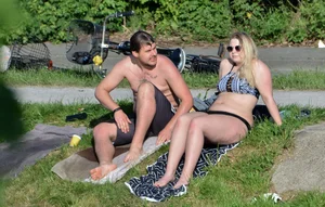 Thick blonde laying out in the sun in a bikini with her boyfriend