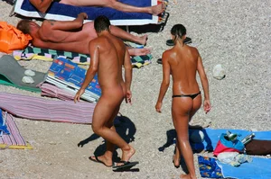 Nudist couple on the beach, girl has amazing tits and nice ass in a thong