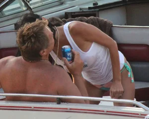Bikini babe on a boat with a wet see through white shirt showing her tits