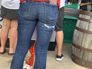 Bunch of girls in various outfits at a Cardinals baseball game