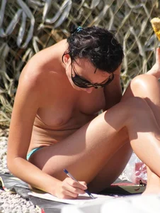 Cute brunette lady topless at the beach with awesome tits