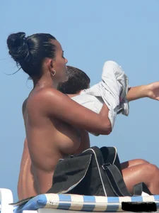Hot ass topless beach girl with great tits lets her little brother oil up her ass in thong bikini