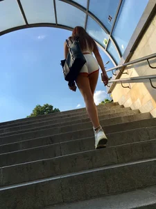Cute candid girl with glasses in white shorts showing cheeks