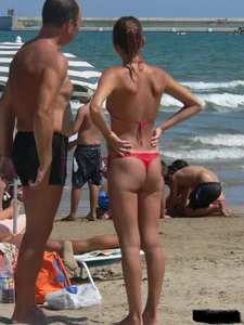 A bunch of hot babes on the beach in thong bikinis