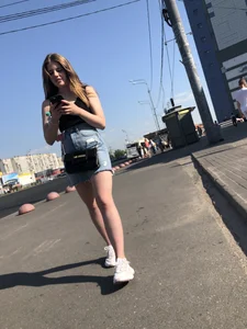 A very cute street candid girl wearing a denim fringed skirt passing by, great legs