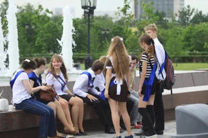 Young College Girls in Dresses, Skirts And Pantyhose Having a Good Time By the City Fountain