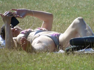 Bikini girl laying out in the park