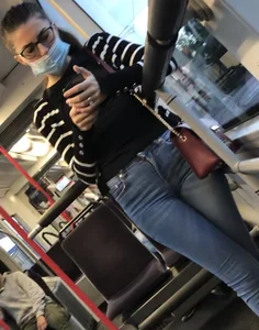 Girl in Glasses and a Mask Standing With Crossed Legs in Tight Jeans Bus Creepshot