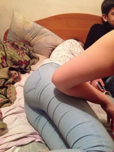 Girl in Blue Tight Jeans Lying in Bed Home Candid