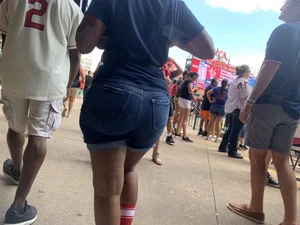 Bunch of girls in various outfits at a Cardinals baseball game