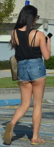 Brunette in short denim shorts showing a little cheek