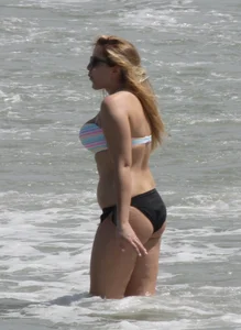 Big boobed thick blonde on the beach in a bikini