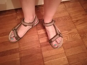 Feet in Sandals with Painted Fingernails Closeup