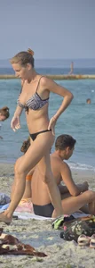 Sexy skinny babe in thong bikini on the beach