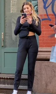 Cute blonde girl in pants and a top street photo