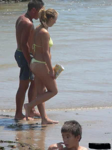 Sexy blonde on the beach in a yellow thong bikini