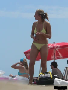Sexy blonde on the beach in a yellow thong bikini