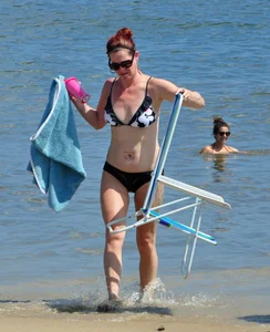 Tattooed redhead milf in a bikini at the beach