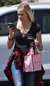 Hot blonde in jeans after shopping at Victoria Secret